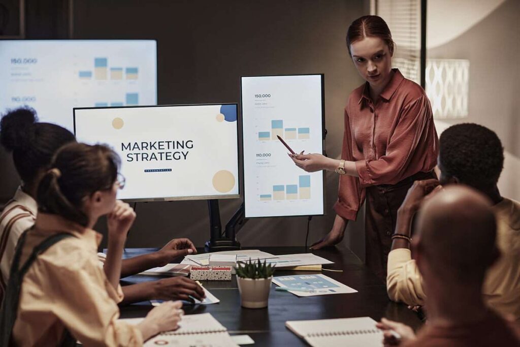 A woman presenting a marketing strategy to her team