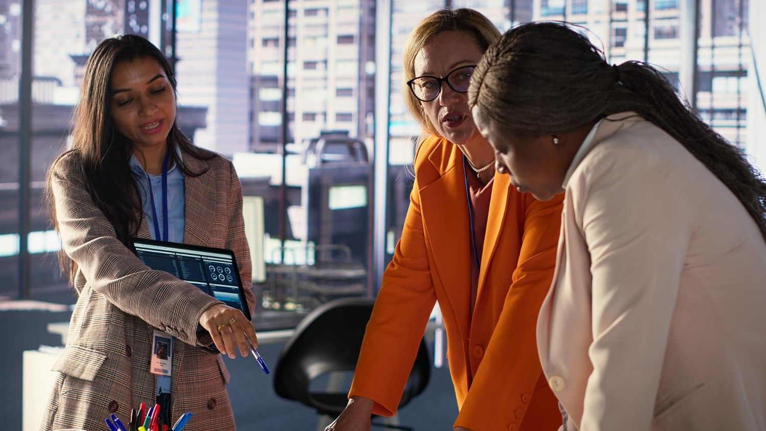 Professional team analyzing digital dashboard