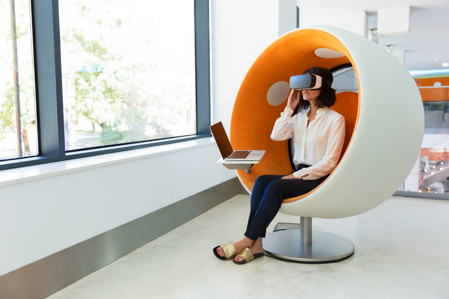 Woman using VR headset in a futuristic pod chair
