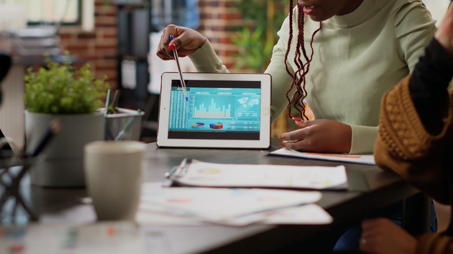 Business professional presenting data on a tablet